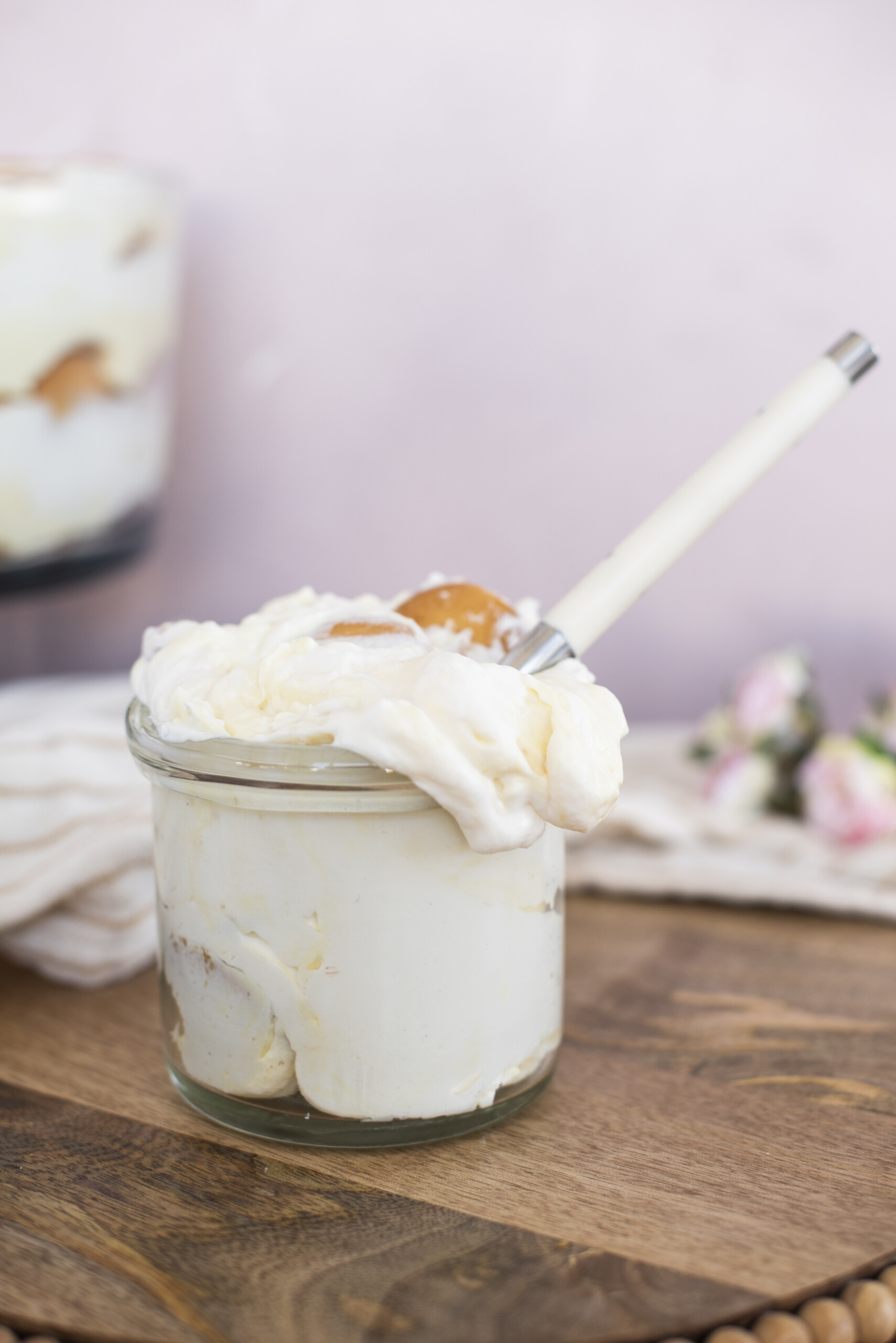 Banana cream pudding in a jar with a spoon.