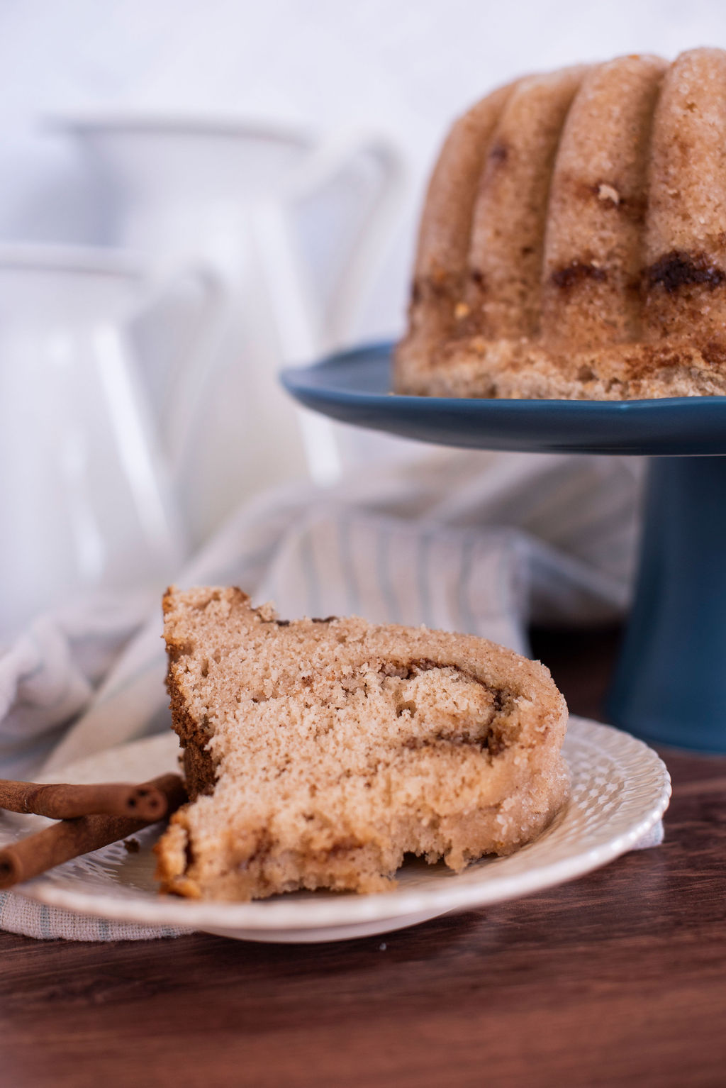 Slice of Snickerdoodle bundt cake on a plate.