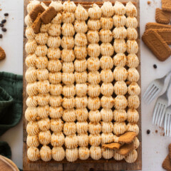 An overhead view of a sheet cake on a cutting board.