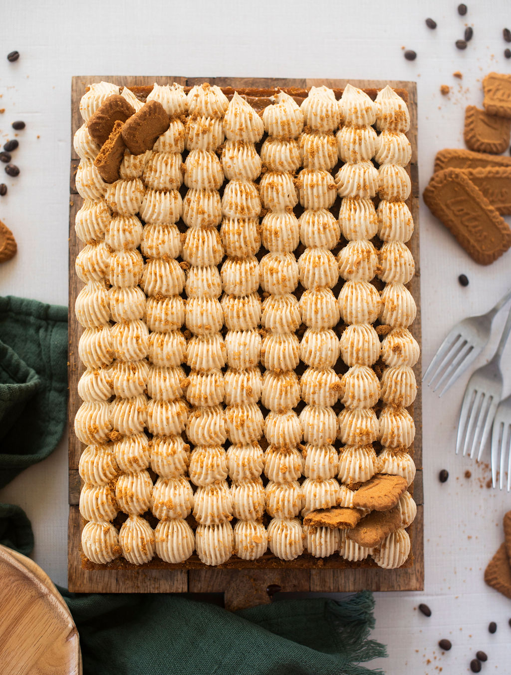 An overhead view of a sheet cake on a cutting board.