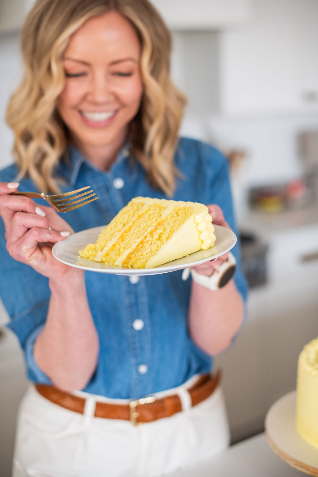 Woman holding a plate of cake.