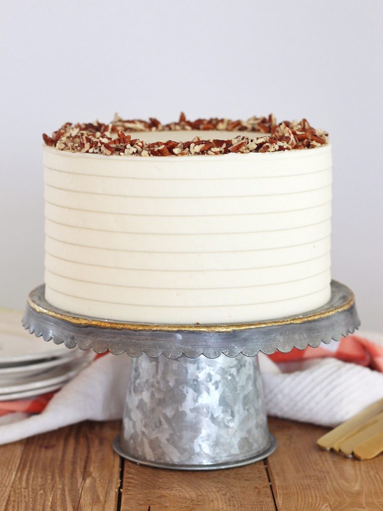 Classic Carrot Cake: incredibly moist, spiced carrot cake layers with a perfectly tangy cream cheese buttercream. #CakebyCourtney #carrotcake #classiccarrotcake #carrotcakewithoutraisins #carrotcakewithoutnuts #carrotcakewithoutnutsorraisins #creamcheesefrosting #creamcheesebuttercream #carrotcakerecipe #thebestcarrotcakerecipe #thebestcarrotcake #eastercake #easterrecipe #easterdessert