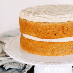 Two layer Banana Chai Cake on a cake stand.