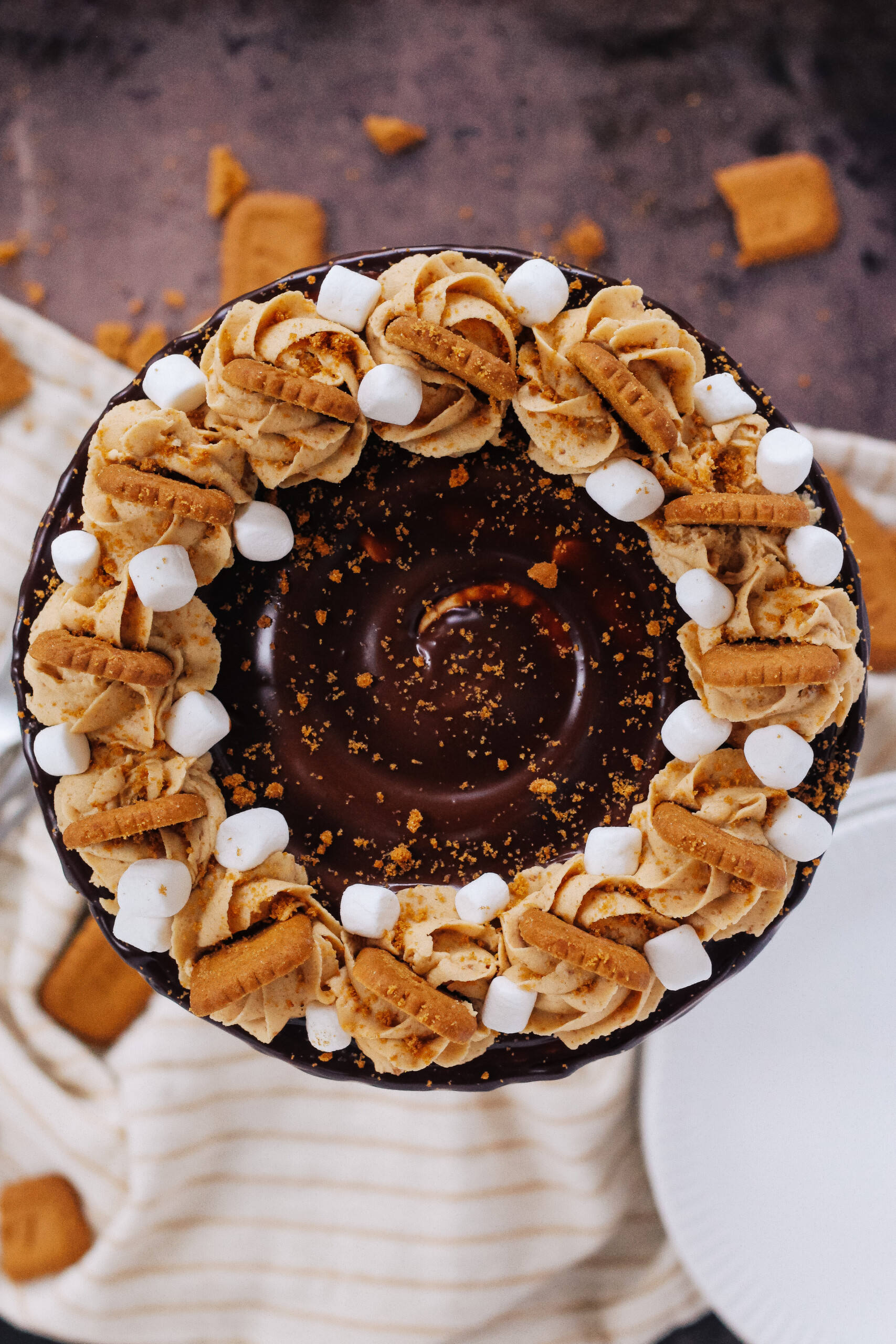 Top view of a cake with swirls and cookies. 