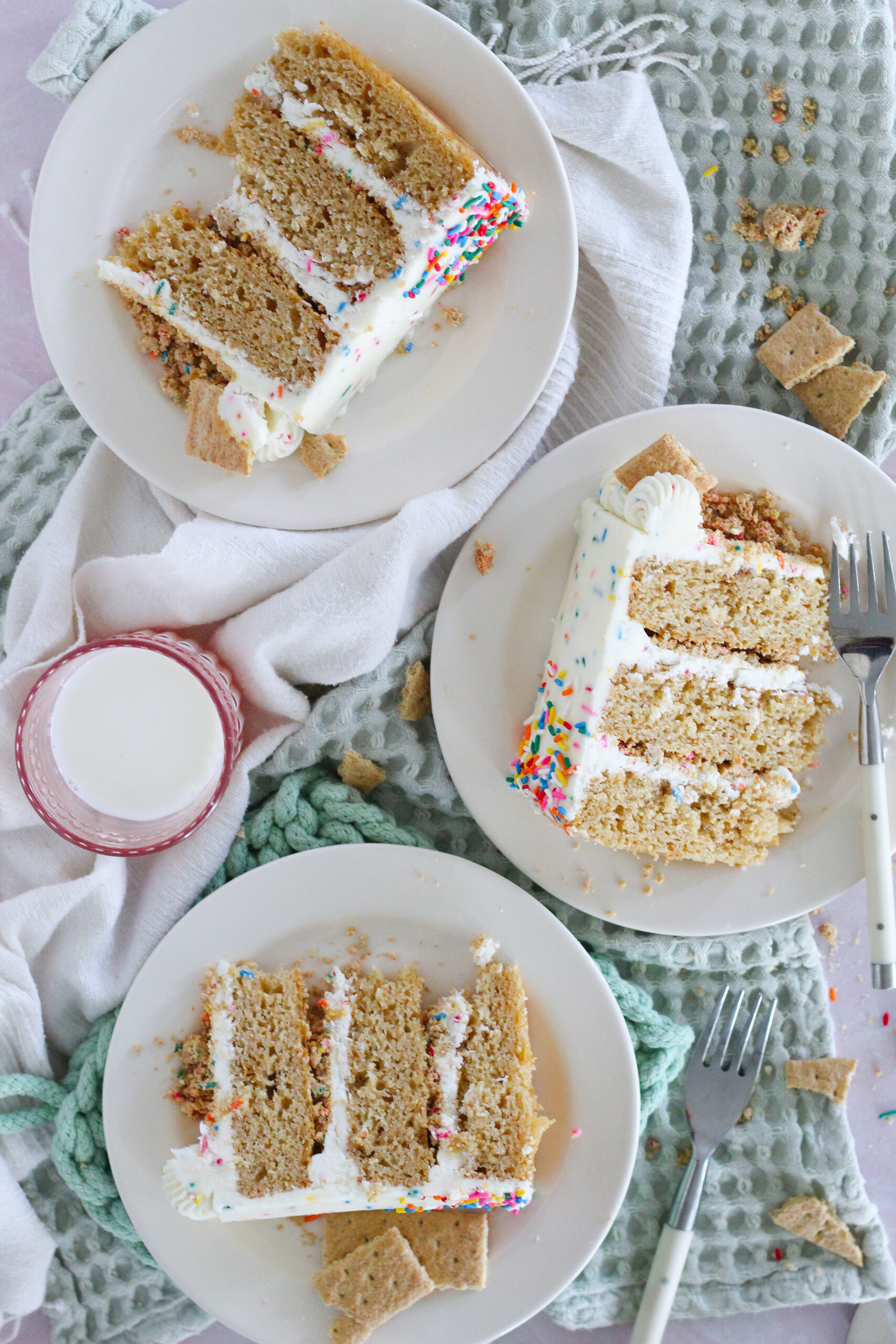 Three slices of cake on a table.