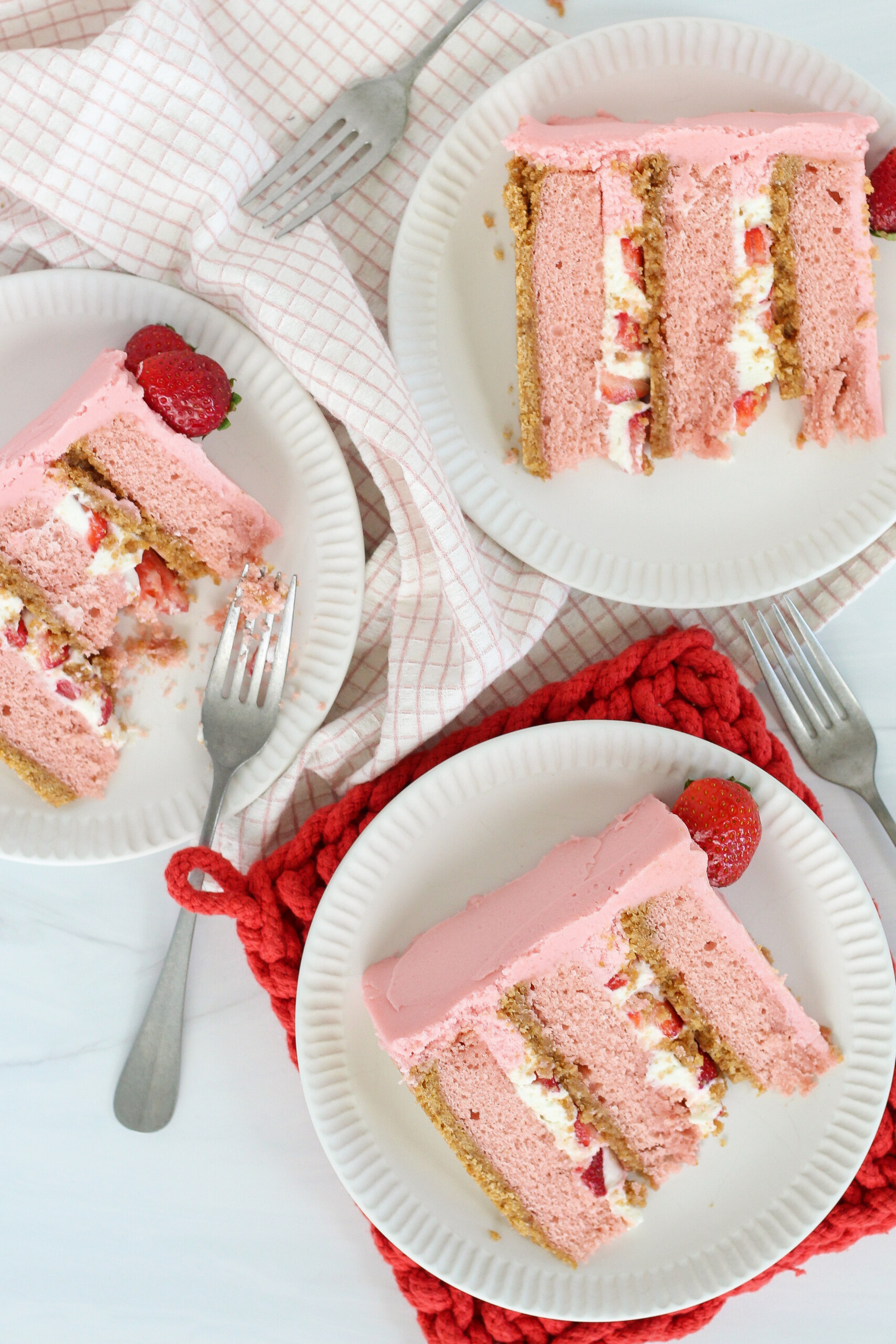 Three slices of cake on plates.