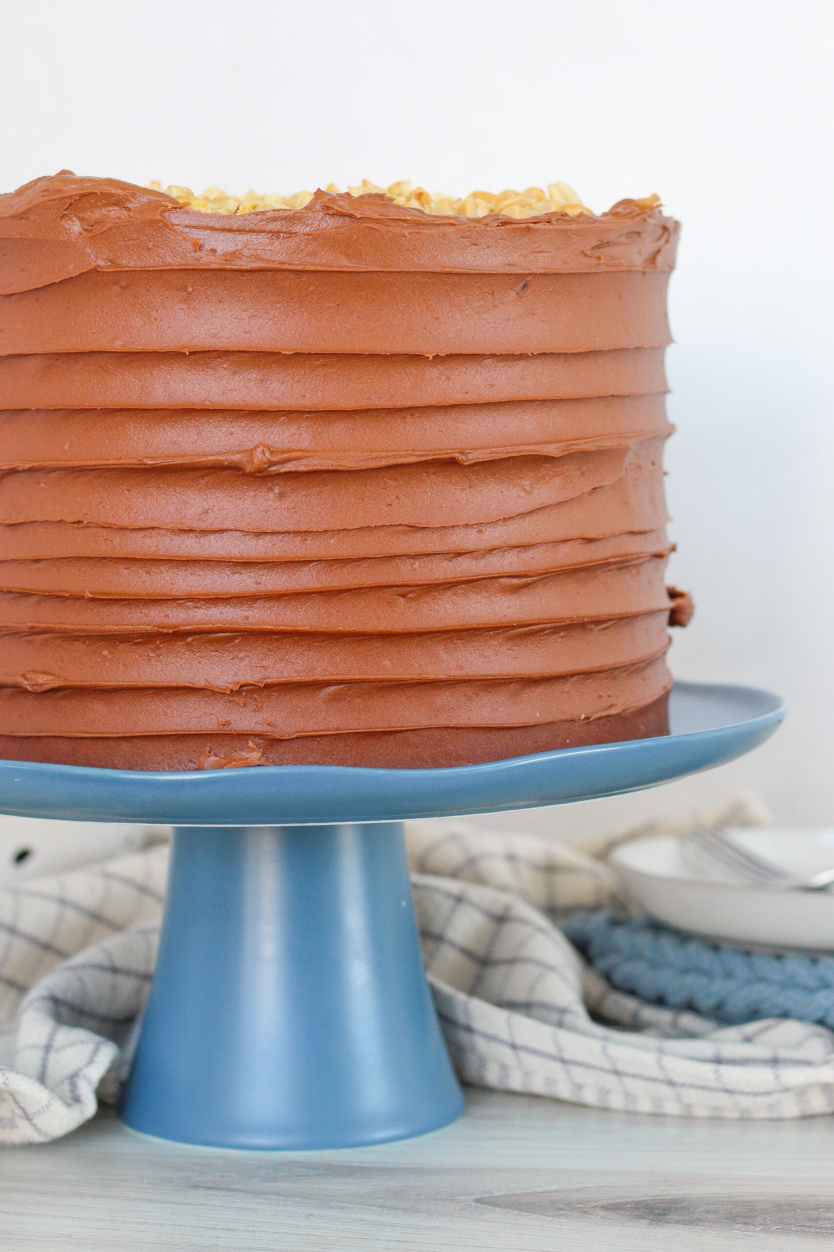 Chocolate cake on a blue cake stand.