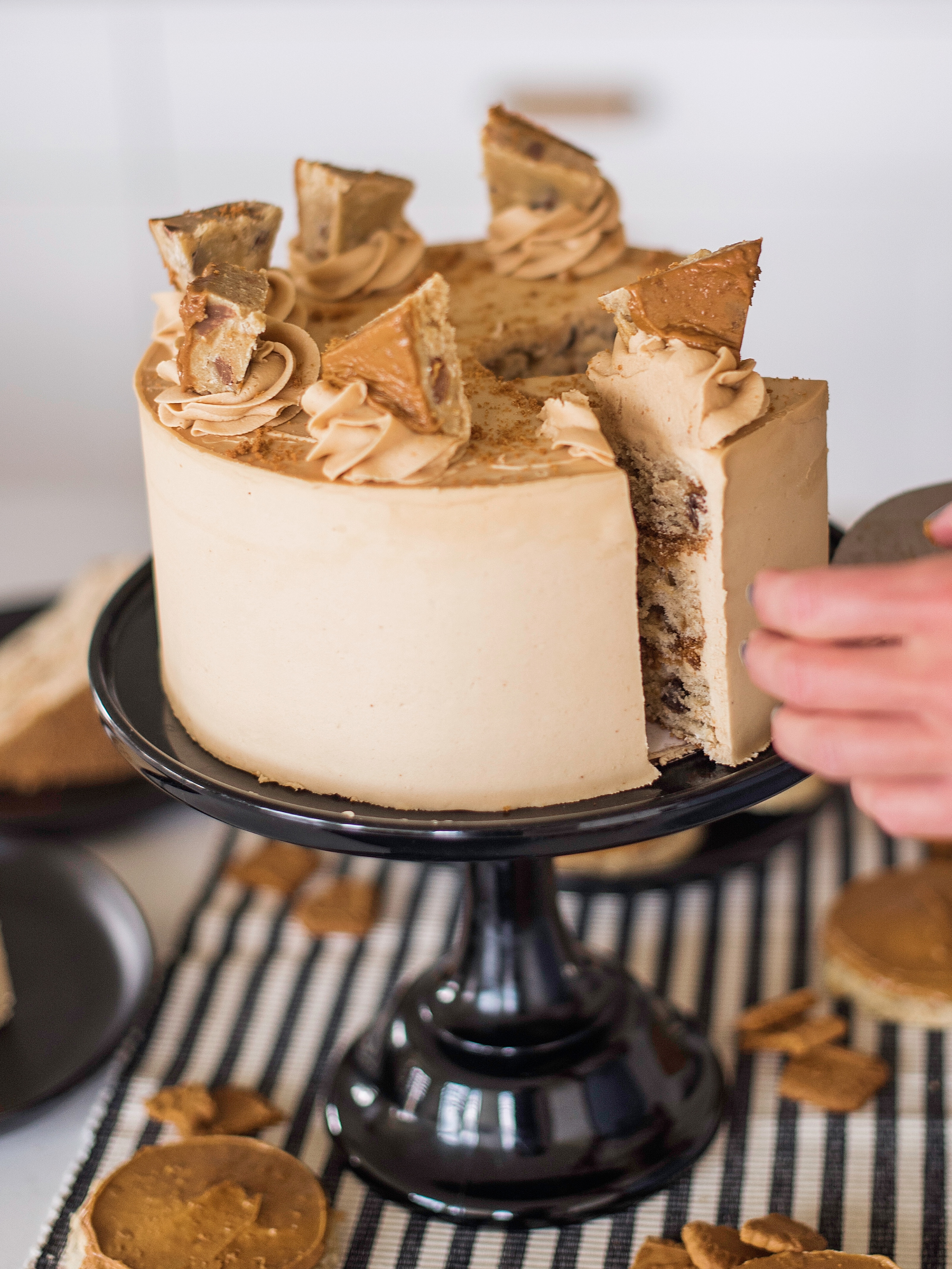 Person taking a slice out of a cake. 