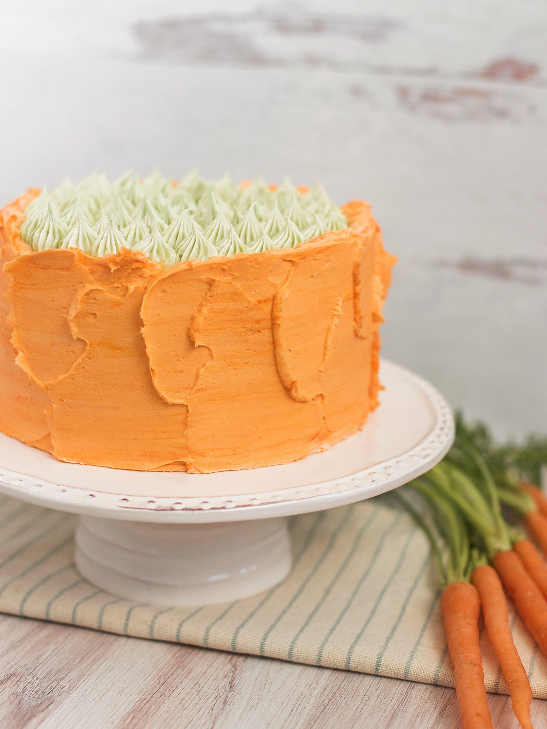 Carrot Apricot Cake - carrot ginger cake layers with white chocolate buttercream, apricot filling and a pretzel crunch #cakebycourtney #carrotcake #whitechocolatebuttercream #cake #eastercake #carrotcakeforeaster #easterdessert