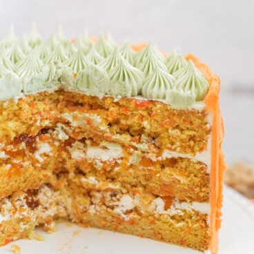 Carrot Apricot Cake - carrot ginger cake layers with white chocolate buttercream, apricot filling and a pretzel crunch #cakebycourtney #carrotcake #whitechocolatebuttercream #cake #eastercake #carrotcakeforeaster #easterdessert