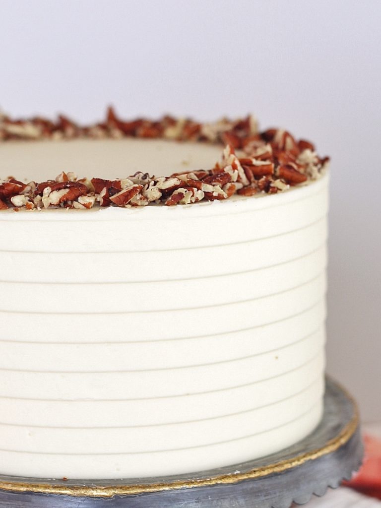 Classic Carrot Cake: incredibly moist, spiced carrot cake layers with a perfectly tangy cream cheese buttercream. #CakebyCourtney #carrotcake #classiccarrotcake #carrotcakewithoutraisins #carrotcakewithoutnuts #carrotcakewithoutnutsorraisins #creamcheesefrosting #creamcheesebuttercream #carrotcakerecipe #thebestcarrotcakerecipe #thebestcarrotcake #eastercake #easterrecipe #easterdessert