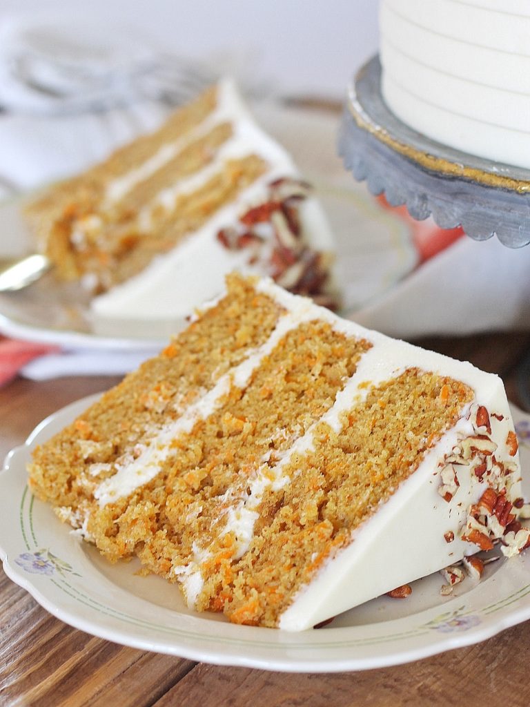 Classic Carrot Cake: incredibly moist, spiced carrot cake layers with a perfectly tangy cream cheese buttercream. #CakebyCourtney #carrotcake #classiccarrotcake #carrotcakewithoutraisins #carrotcakewithoutnuts #carrotcakewithoutnutsorraisins #creamcheesefrosting #creamcheesebuttercream #carrotcakerecipe #thebestcarrotcakerecipe #thebestcarrotcake #eastercake #easterrecipe #easterdessert