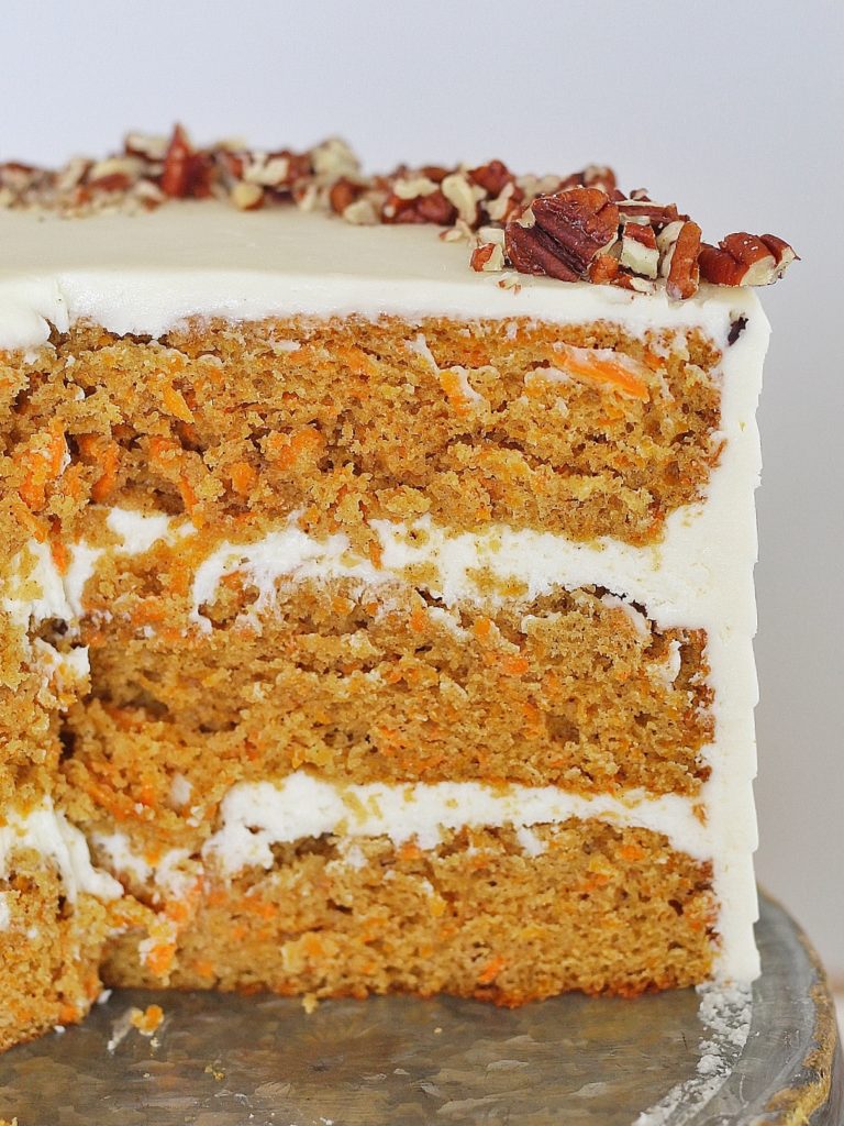 Classic Carrot Cake: incredibly moist, spiced carrot cake layers with a perfectly tangy cream cheese buttercream. #CakebyCourtney #carrotcake #classiccarrotcake #carrotcakewithoutraisins #carrotcakewithoutnuts #carrotcakewithoutnutsorraisins #creamcheesefrosting #creamcheesebuttercream #carrotcakerecipe #thebestcarrotcakerecipe #thebestcarrotcake #eastercake #easterrecipe #easterdessert