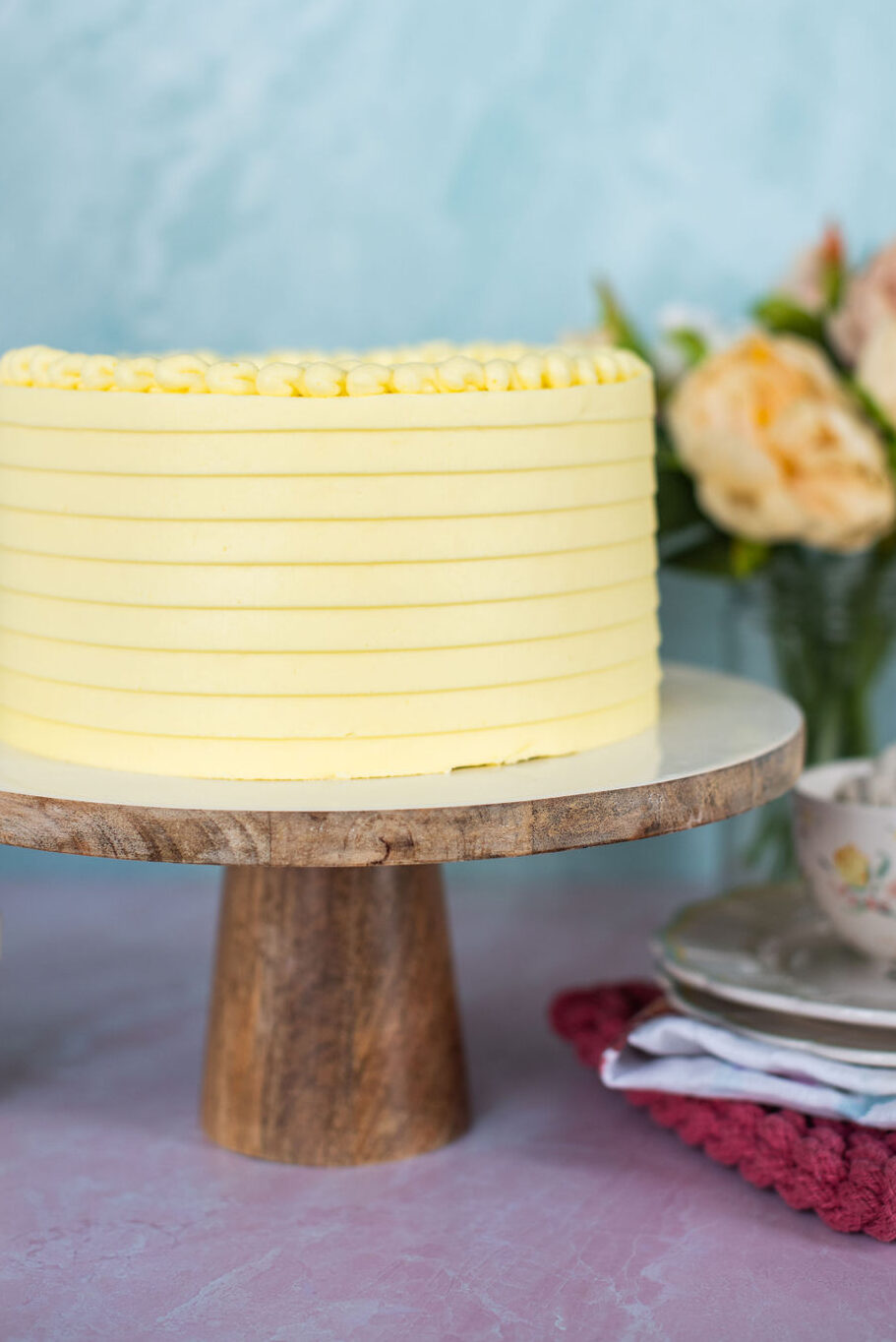 Yellow lemon cake on a cake stand.