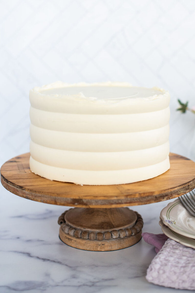 Cake on a cake stand with flowers.